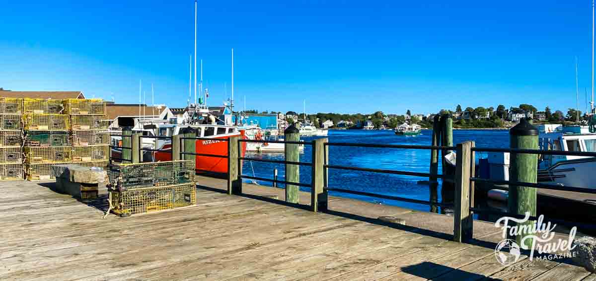 Dock in Gloucester with lobster traps and boats in harbor
