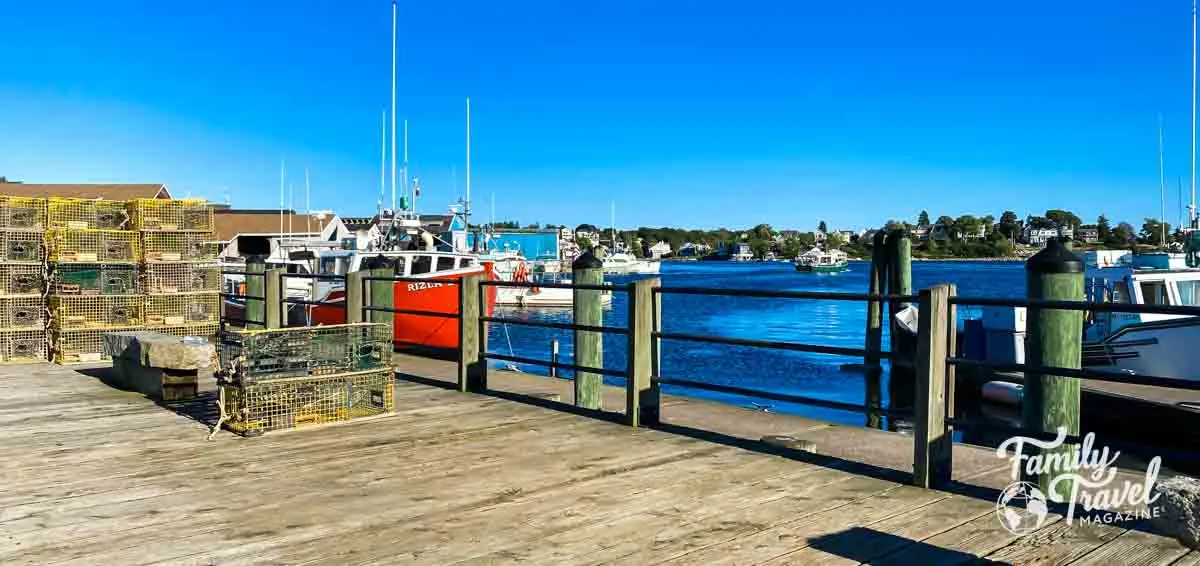 Dock in Gloucester with lobster traps and boats in harbor