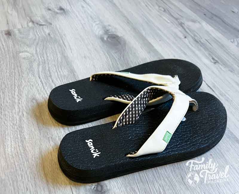 Black flip flops with white strap
