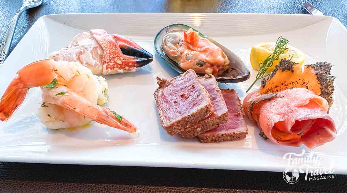 seafood plate with shrimp, salmon, tuna, mussel, and crab claw