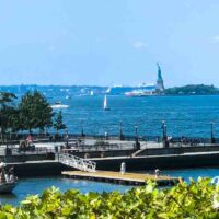 Statue of Liberty in New York Harbor with pier in foreground