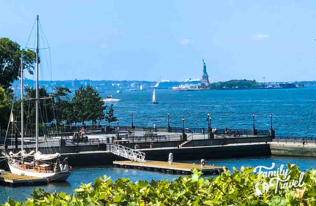 Statue of Liberty in New York Harbor with pier in foreground