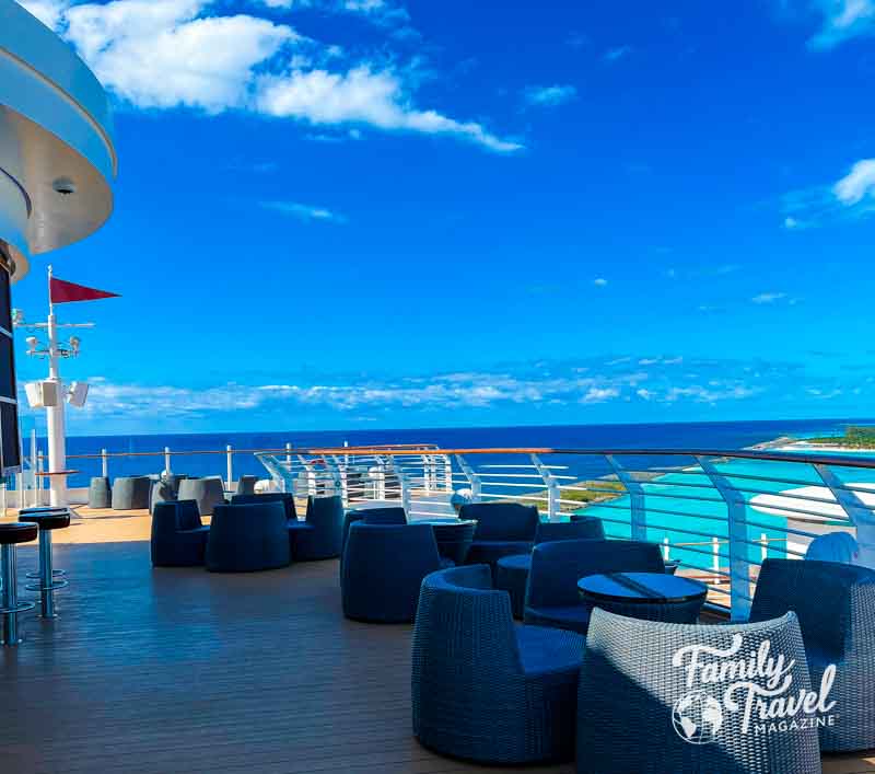 chairs and tables by pool bar on Disney Cruise