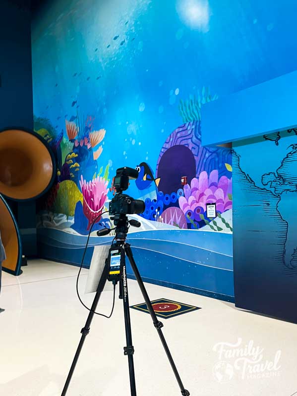 colorful Finding Nemo mural with a camera on tripod in foreground
