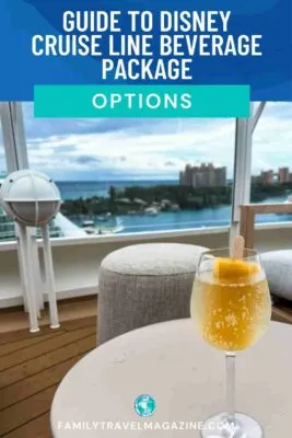 a cocktail with a popsicle in it sitting on a table with a view of the ocean