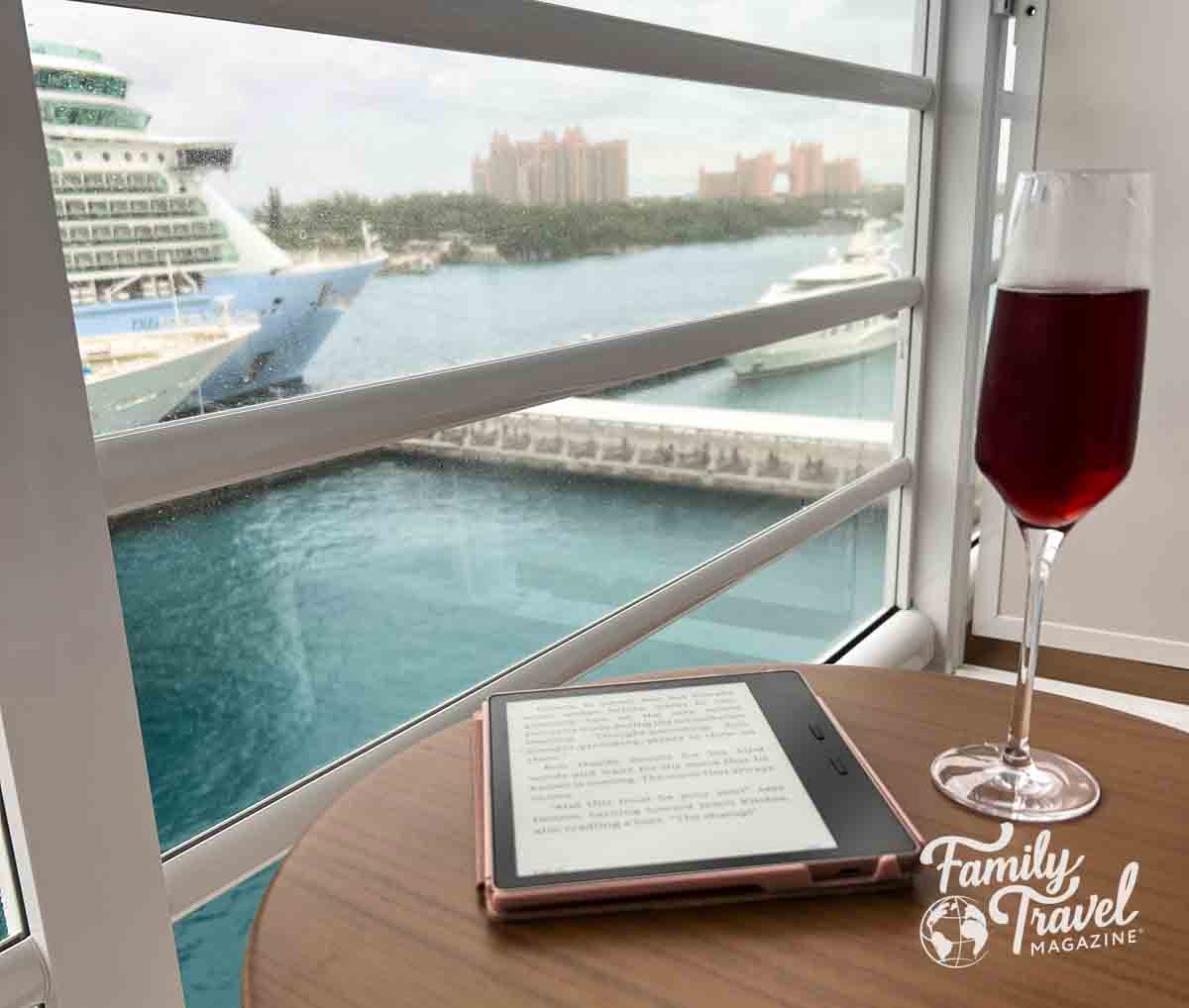 dark pink champagne in glass with kindle on table overlooking Atlantis