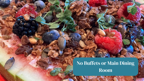 No buffets or main dining room text on photo of watermelon with berries and granola. 