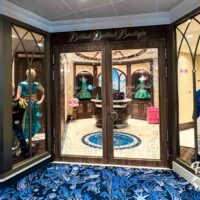 Entrance to the Bibbidi Bobbidi Boutique on board the Disney Wish with mannequins in the window.