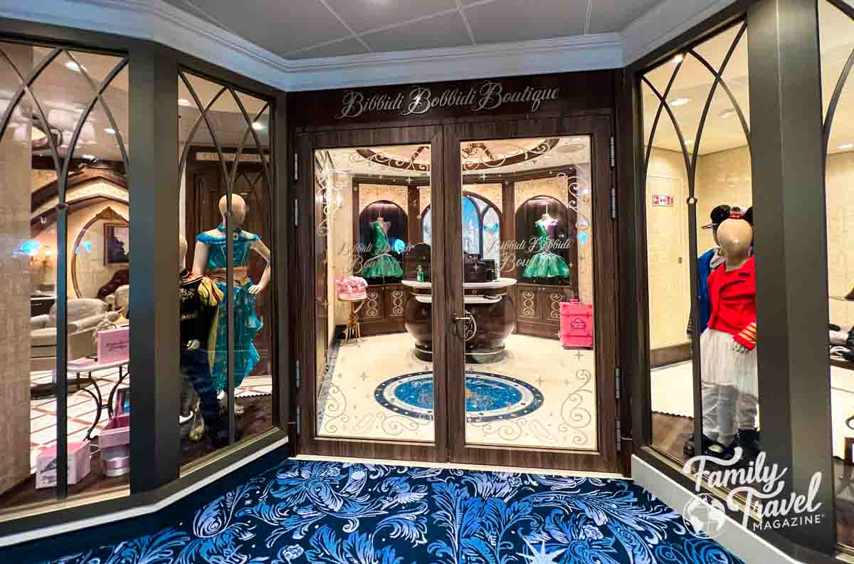 Entrance to the Bibbidi Bobbidi Boutique on board the Disney Wish with mannequins in the window. 