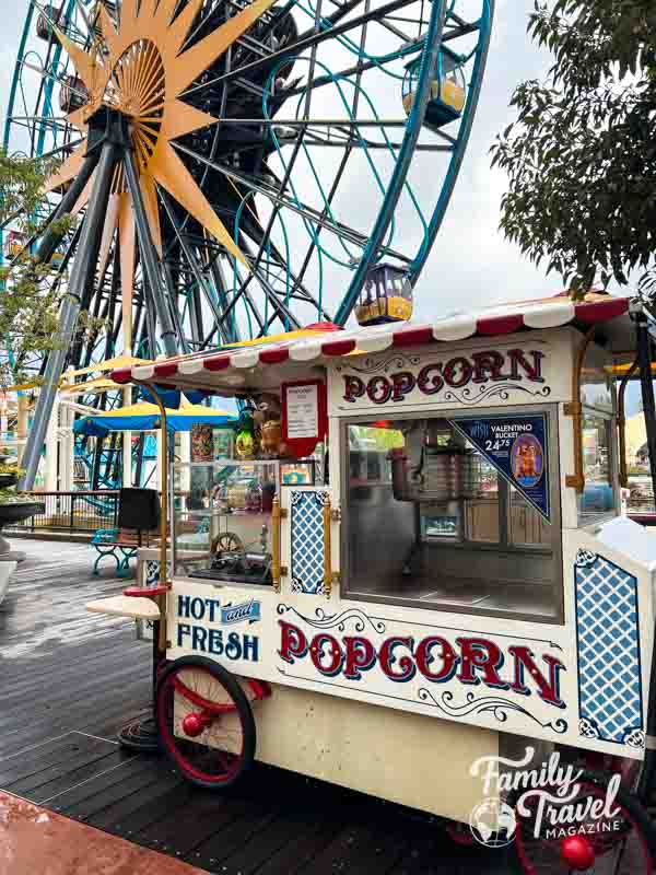 Popcorn cart in front of ferris wheel