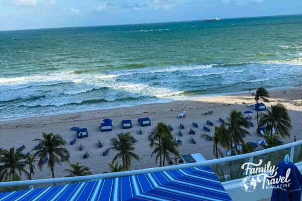 A view of the beach from the balcony of a hotel