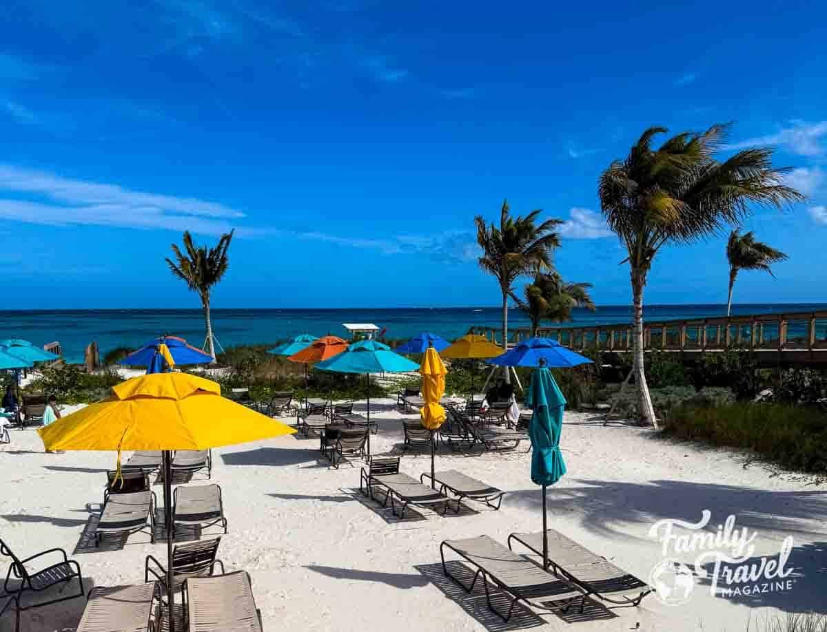 Beach at Lookout Cay at Lighthouse Point with palm trees, umbrellas, and chairs