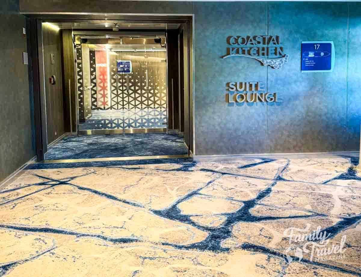 Entrance to the Coastal Kitchen and Suite Lounge on a Royal Caribbean cruise ship, featuring modern decor and a plush ocean-inspired carpet design on Deck 17.
