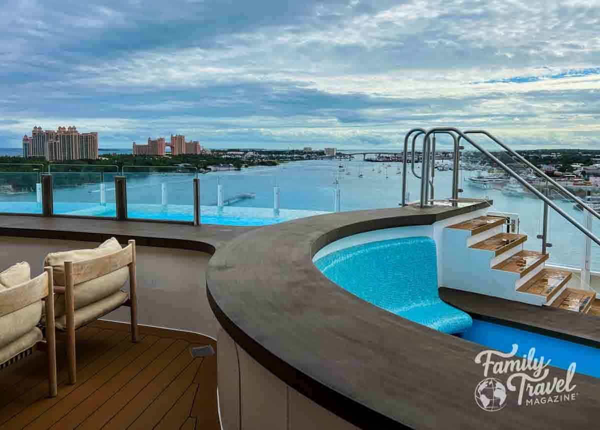 Infinity pool view from the Disney Wish cruise ship overlooking Nassau Harbor and Atlantis Resort in the Bahamas.