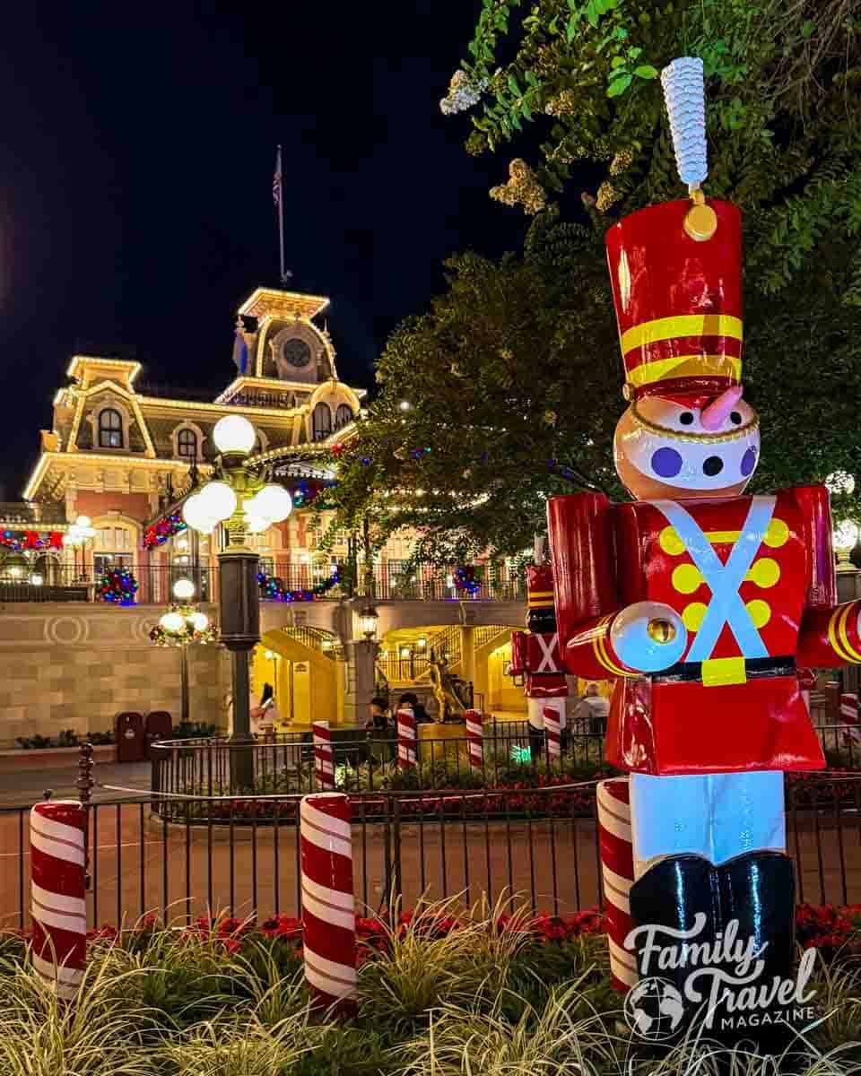 Large toy soldier decoration stands in front of a building at night.