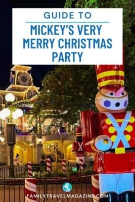 Toy soldier decoration stands in front of the Magic Kingdom train station with holiday lights.