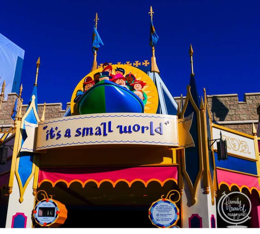 The vibrant its a small world attraction entrance with a blue sky at a Disney Park.