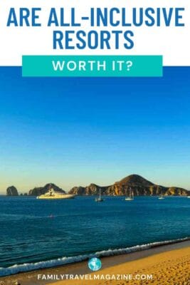 El Arco de Cabo San Lucas and Lands End rock formations in a sunny bay with boats and a sandy beach.
