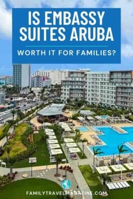 Aerial view of the Embassy Suites Aruba resort with multiple swimming pools, cabanas, and modern buildings.