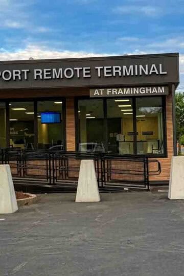 Exterior of the Logan Airport Remote Terminal at Framingham under a cloudy sky.