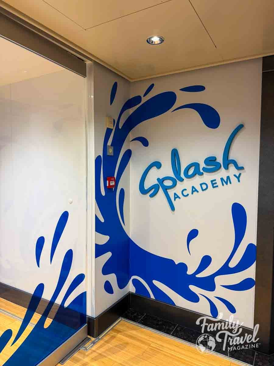 A wall features a blue graphic of a water splash and the text Splash Academy in blue lettering.
